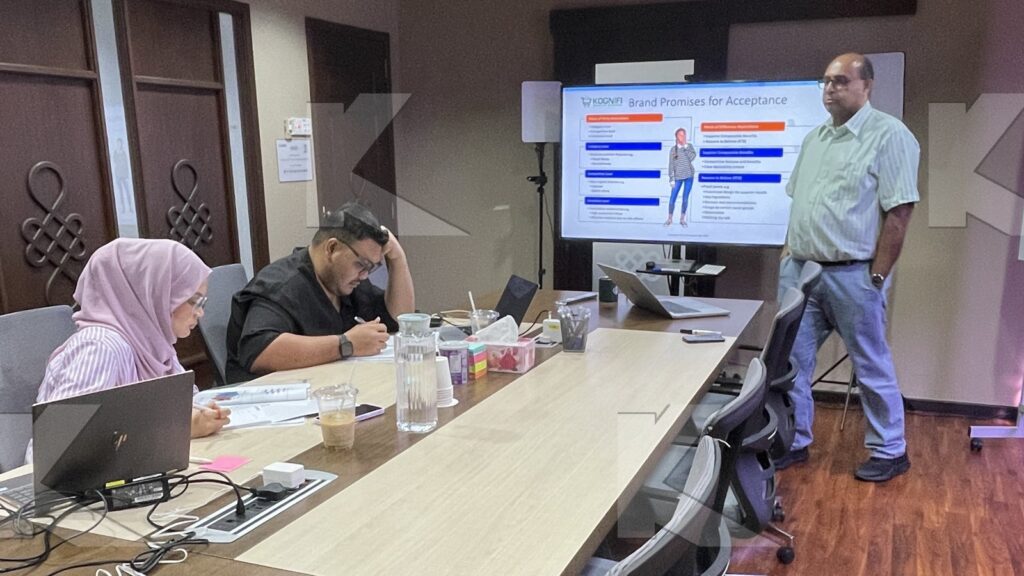 The trainer presents while participants write in a Kognifi Brand Strategy class