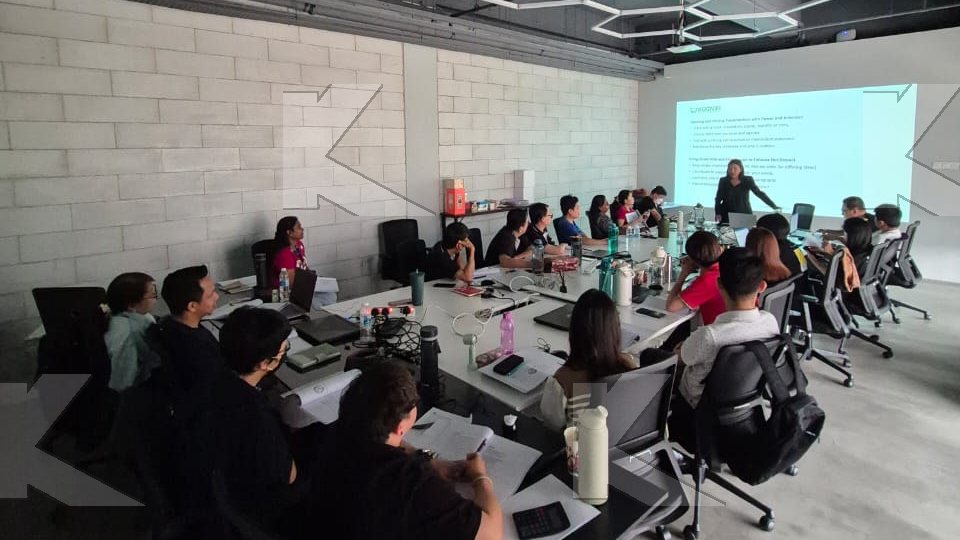Participants work through an exercise at their tables in a Kognifi Power of Business Communication Skills class