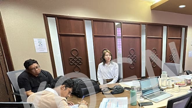 Participants work at the table in a Kognifi Business Communication Skills class