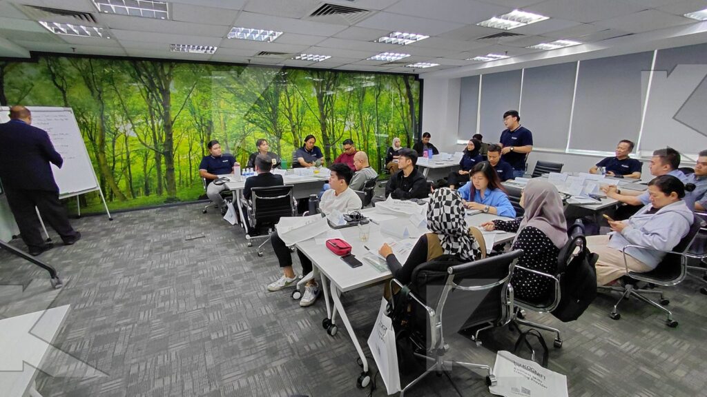 Teams work on a flipchart activity in a Kognifi Business Communication, Negotiation and Data Visualization class