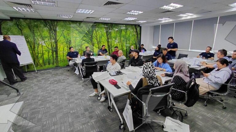 Teams work on a flipchart activity in a Kognifi Business Communication, Negotiation and Data Visualization class