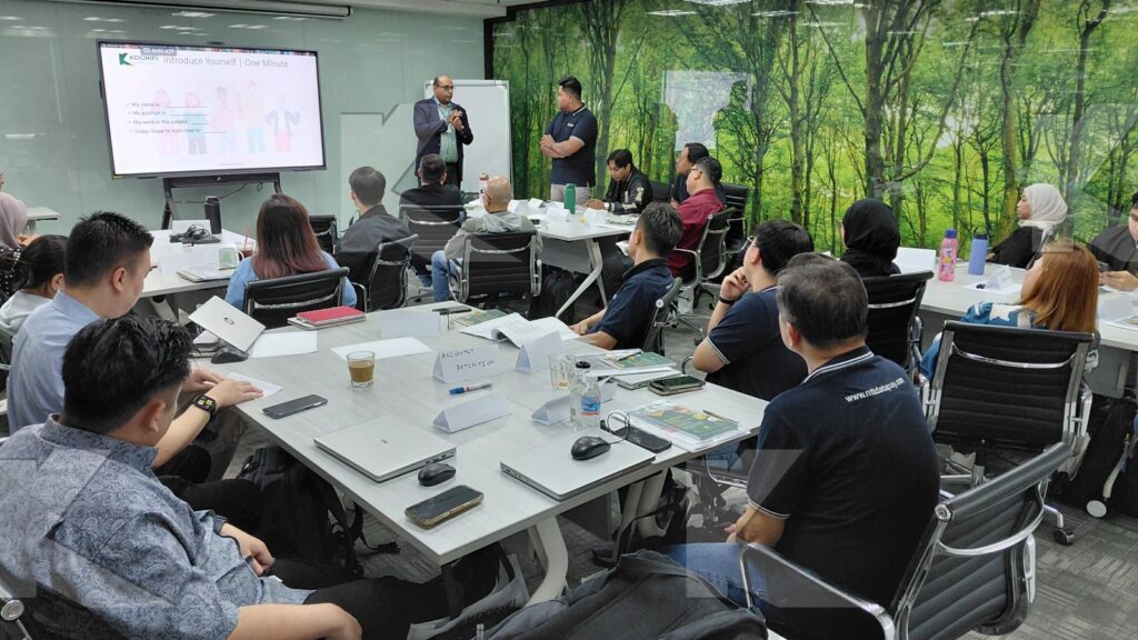 The trainer presents to the full room in a Kognifi Business Communication, Negotiation and Data Visualization class