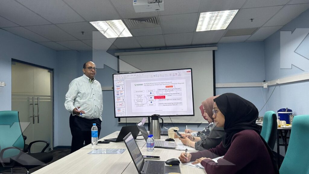 The trainer explains a chart in a Kognifi Business Presentation with Data Visualization class
