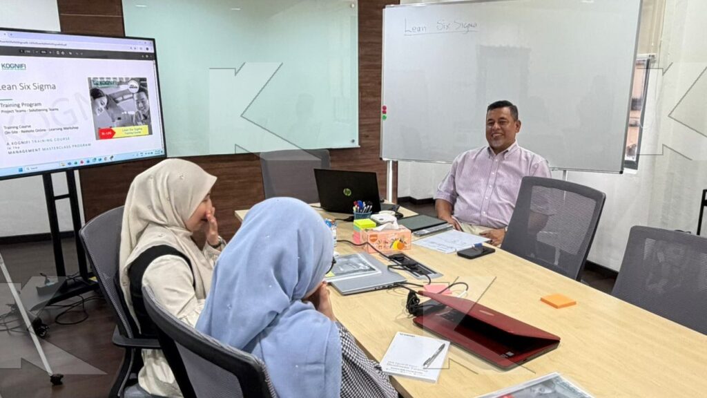 The trainer talks with participants in a Kognifi Lean Six Sigma class