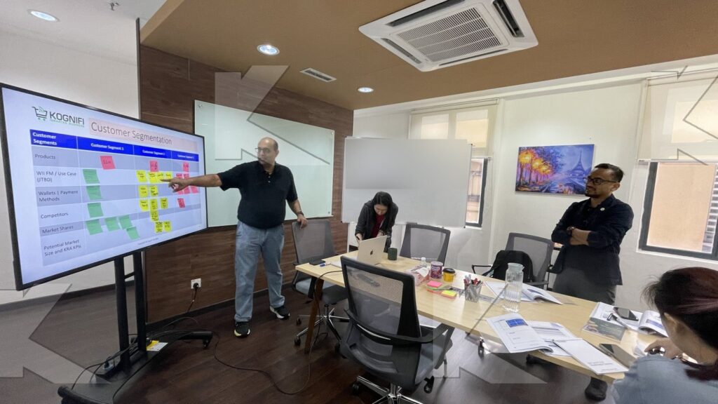 The trainer reviews the segmentation board in a Kognifi Marketing Management class