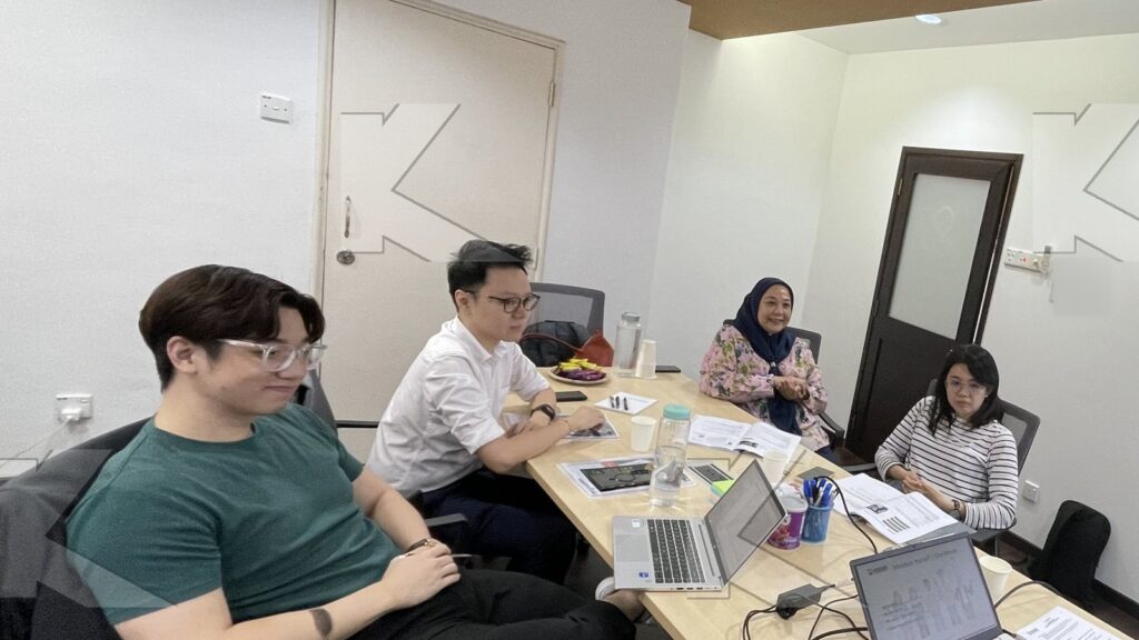 Participants with laptops in a Kognifi Negotiation Skills class