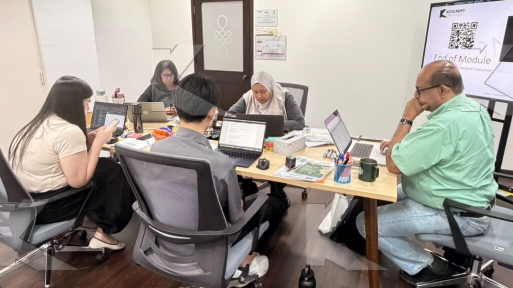 Participants and the trainer work on SEO copy at the table in a Kognifi SEO Copywriting class