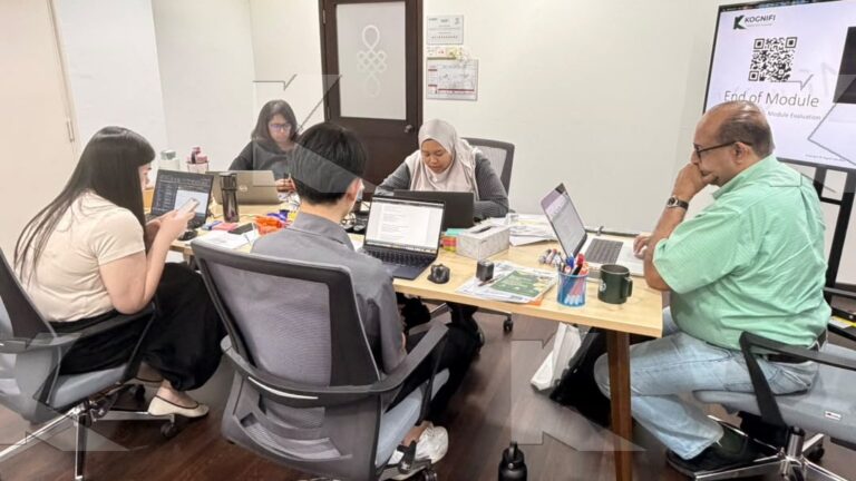 Participants and the trainer work on SEO copy at the table in a Kognifi SEO Copywriting class